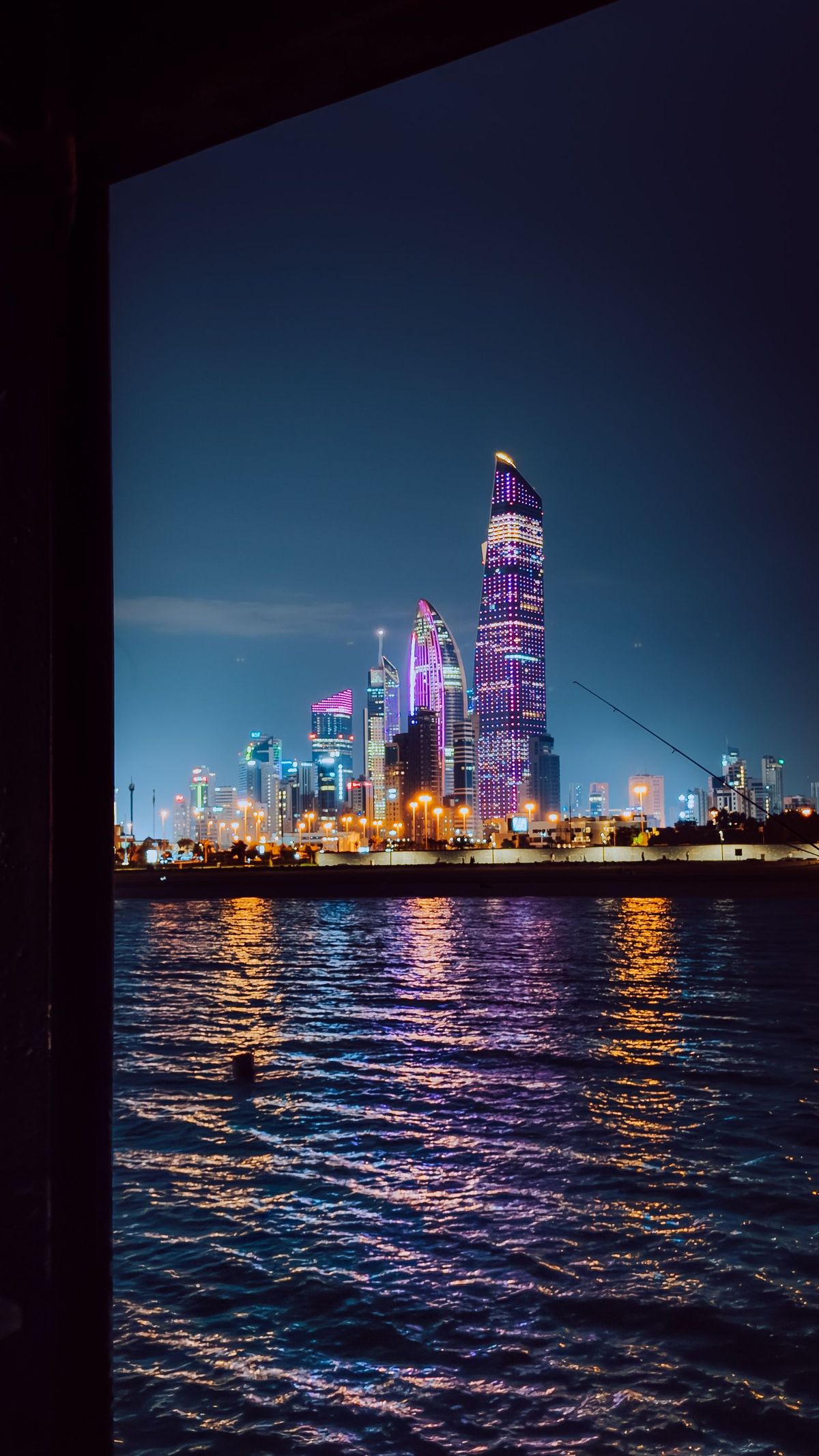 Illuminated waterfront skyline at night
