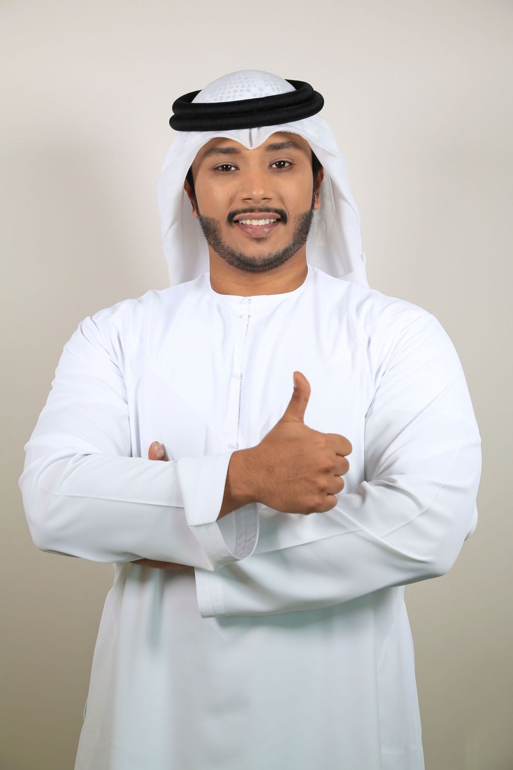 Smiling client in a white thobe and ghutra