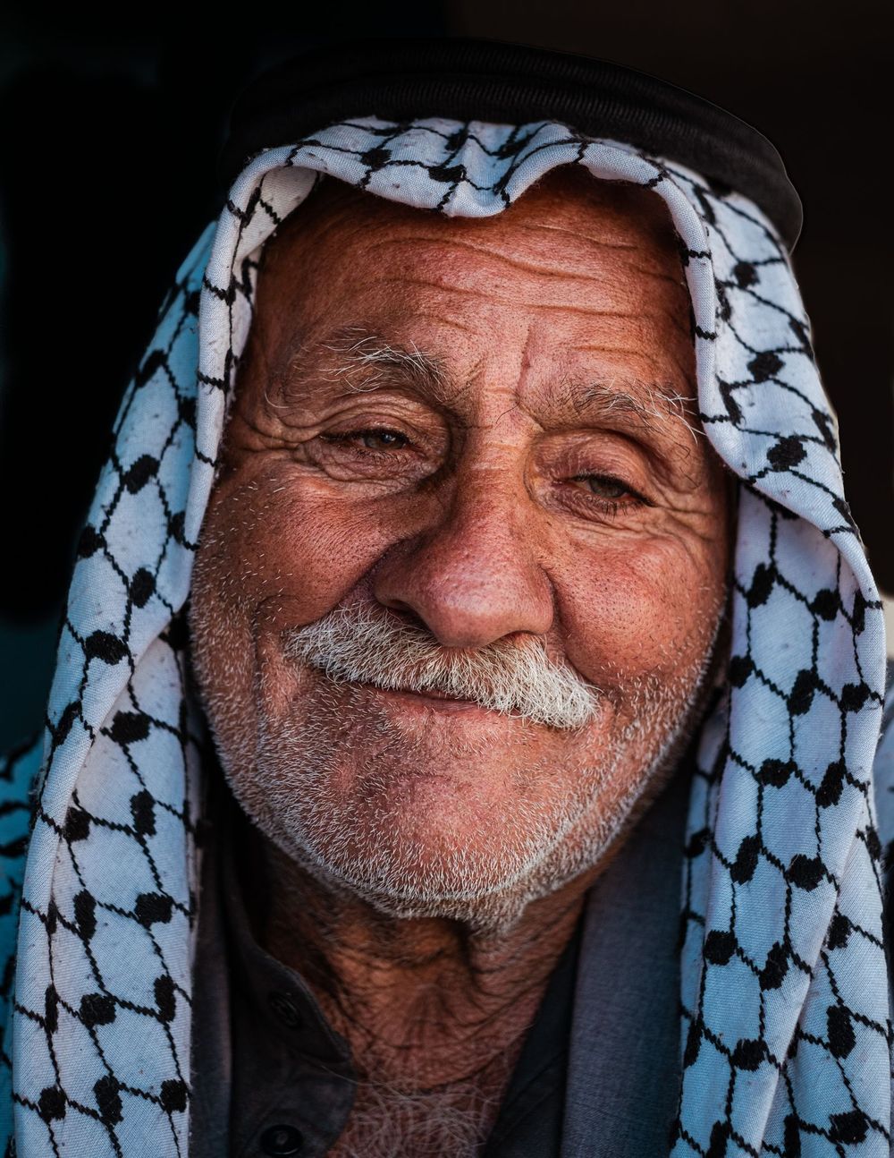 Smiling elderly client wearing a shemagh